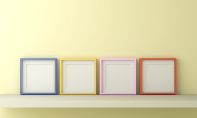 Blank yellow blue pink and orange picture frame for insert text or image inside on light yellow color wall.
