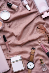 Fashion cosmetic feminine women accessory items gifts on flat lay pink beige pastel vertical...