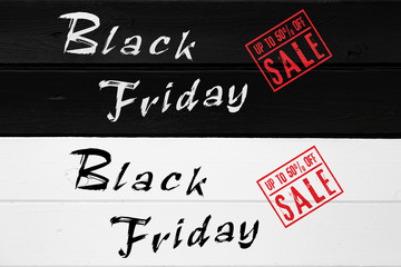 Black Friday sale banner on a black and white painted wooden table. Includes up to 50% off sale stamp in red.