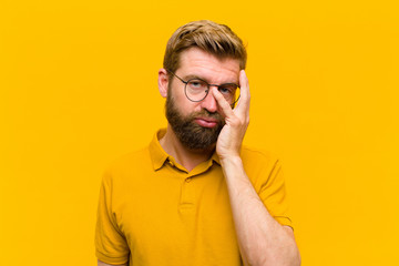 young blonde man feeling bored, frustrated and sleepy after a tiresome, dull and tedious task,...