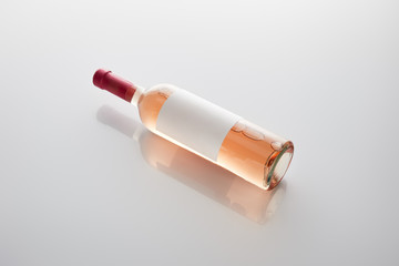 bottle with rose wine and blank label on white background