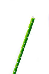 Closeup of drinking straw for party.  Green with white dots. Top view of colorful disposable eco-friendly straw for summer cocktails. Paper coctail colorful straw on white  background, isolated.