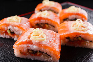 Japanese food, tasty of meal for lunch. Seafood. Sushi with eel, salmon, trout, tuna black background.