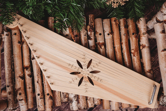 "Kokle" a Latvian national musical instrument similar to the harp, zither. A Latvian plucked string instrument (chordophone) belonging to the Baltic box zither family known as the Baltic psaltery.