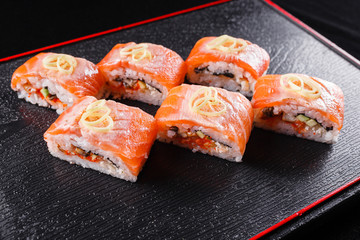 Japanese food, tasty of meal for lunch. Seafood. Sushi with eel, salmon, trout, tuna black background.
