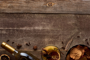 top view of traditional pear mulled wine with spices on wooden rustic table with copy space