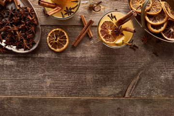 top view of traditional pear mulled wine with spices on wooden rustic table with copy space
