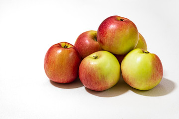 ripe garden apples lie on a white textured background