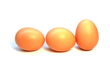 Three chicken eggs in a row