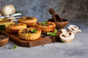 Puff pastry cake with mushrooms on a concrete background.