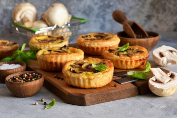 Puff pastry cake with mushrooms on a concrete background.