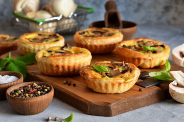 Puff pastry cake with mushrooms on a concrete background.