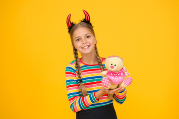 Girlish temper. Cute but dangerous. Halloween concept. Small adorable child with red horns....
