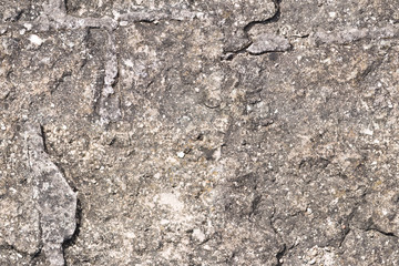Seamless texture of a fortified wall made of natural stone with relief.