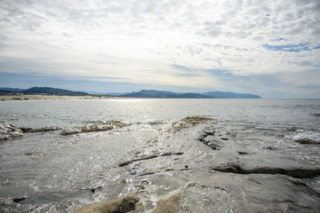 Sandy rock and ocean or sea. blue sky, clear weather