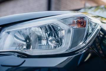 Close up view of clean, polished headlamp of modern car