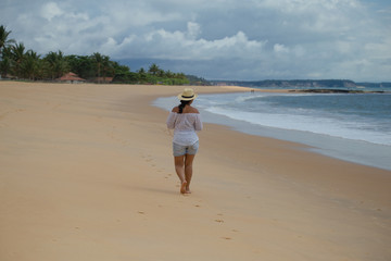 A woman walking in the beach 