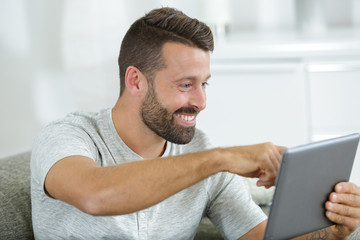 man with a tablet is pointing at something