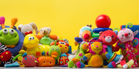Colorful kids toys frame on wooden background. Top view. Flat lay. Copy space for text.