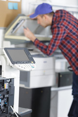 man fixing printer