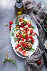 Italian bruschetta with chopped tomatoes, basil and mozzarella on grilled crusty bread