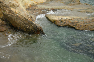 Texture of water and stone, top view. Ocean, sea