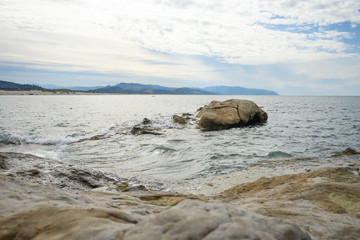 Fototapeta na wymiar stones in water. waves of the ocean or sea beat against the rocks