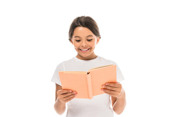 Obraz premium positive kid smiling while reading book isolated on white