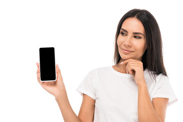 Fototapeta premium pretty woman looking at smartphone with blank screen isolated on white