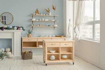 Kitchen-studio with the wooden table, shelf and big winodw
