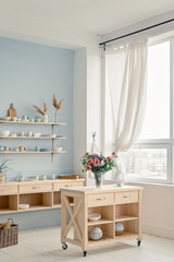 Modern bright kitchen with big window, table and shelf