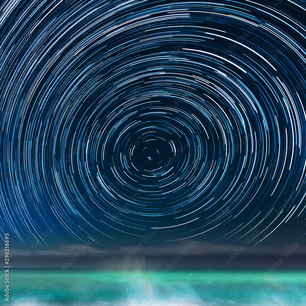 Wall mural star-trails above the caribbean sea, in jamaica, with the northern star in the center of the image.