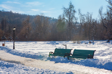winter snowy park with bench