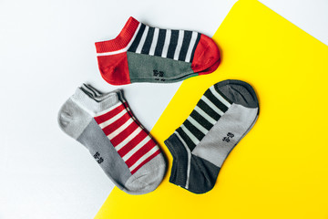 Baby socks on a yellow-white background