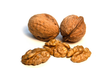 Walnuts in a shell and without it on a white background