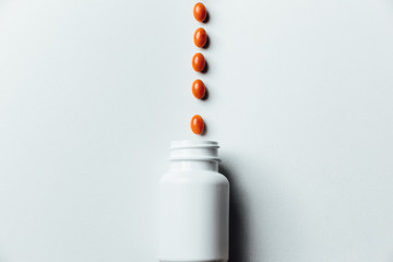 Assorted pharmaceutical medicine pills, tablets and capsules and bottle on white background. Copy space for text