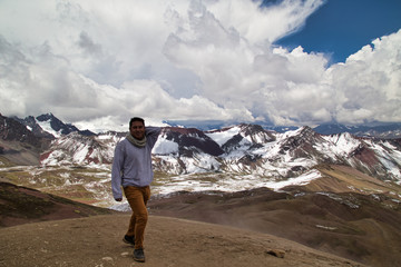 Man with panoramic view. Hiking scene in Vinicunca, Cusco region, Peru. Montana of Seven Colors, Rainbow Mountain