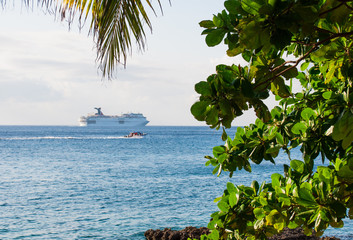Cruise ship far at the horizon on the Caribbean sea, view from Cozumel Island, Mexico