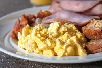 Egg and ham breakfast served on a white plate