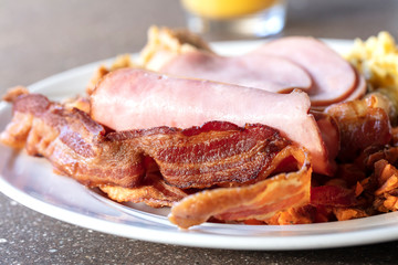 Bacon, Eggs and Ham breakfast served on a white plate