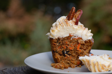 Carrot Cake Cupcake with Cream Cheese Icing with an Autumn Background