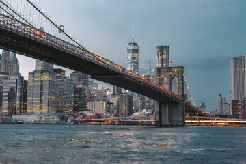 Fototapeta premium Brooklyn Bridge and Manhattan Skyline on a Moody Night After Sunset on the East River from Brooklyn Waterfront in Dumbo