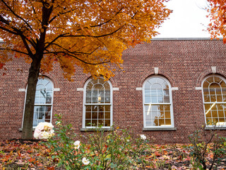generic red brick building in front of garden in the fall