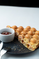 Close up of Hong Kong bubble waffle with sausage and cheese on white flat lay