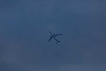 blurred image of plane against the blue sky.