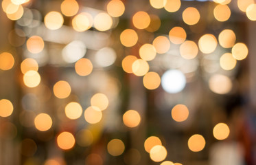 Fototapeta premium Blurred bokeh lights in orange circles to gold.