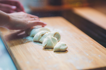Woman prepare dumpling skin, Making dough  on wooden table