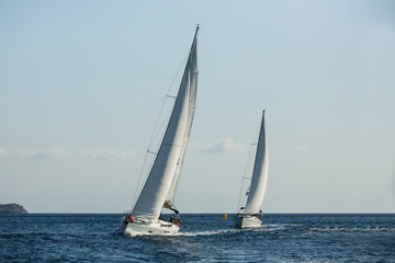 Sailing ship yachts with white sails in the Aegean sea during sail regatta..
