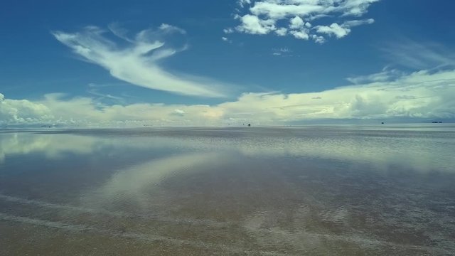 Aerial of four wheel drive vehicles cross the flooded Salar de Uyuni, world's largest salt flat, near Daniel Campos Province, Bolivia. Drone very slow forward dolly