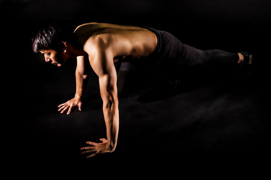 sport man at fitness gym club doing push up exercise for body and showing muscle bodybuilding on black backgrounds, fitness concept, sport concept